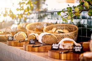 a display of breads and baskets of bread on a counter at Van der Valk Hotel Delft A4 in Den Hoorn