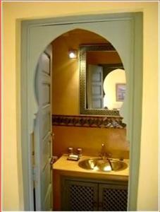 a bathroom with a sink and a mirror at Riad Herougui in Marrakesh