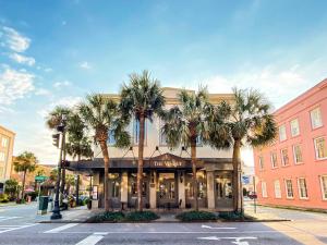 a building with palm trees in front of a store at The Vendue, Downtown Art Hotel in Charleston