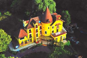 an aerial view of a large yellow house at Appartement studio cosy O fil de l'O à 10 mn de Disney in Crecy la Chapelle