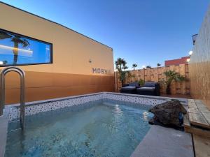 a swimming pool in front of a building at Morning Beach Pension in Jeju