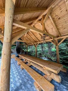 a large wooden pavilion with a wooden roof at Wild tree house in Vărşag