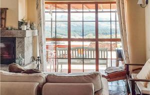 a living room with a couch in front of a large window at 3 Bedroom Beautiful Home In Navarredonda De Gredos in Navarredonda de Gredos