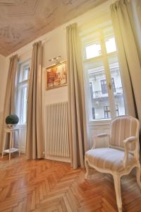 a living room with a chair and a window at Nadi's Home – Heart of Budapest in Budapest