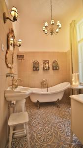 a bathroom with a tub and a sink at Nadi's Home – Heart of Budapest in Budapest