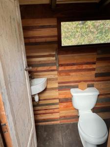 a bathroom with a toilet and a sink at Cabañas Lickanantay in Puerto Varas