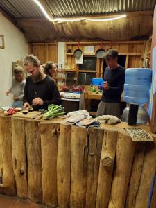 a group of people in a kitchen preparing food at The Hub - Centro Sakbe in San Juan La Laguna