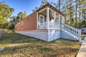 a small house with a porch and a deck at Chic Cottage Retreat with Grill, 2 Mi to MSU! in Starkville