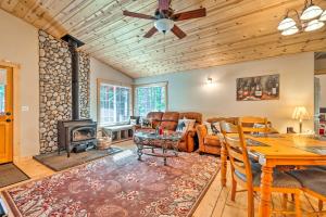a living room with a table and a fireplace at Arnold Cabin with EV Charger, Fire Pit and Hikes! in Arnold