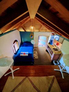 a living room with a blue couch and a table at Troncones Point Hostel in Troncones