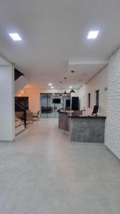 an empty office space with a reception desk and tables at Pousada Barbosa in Aparecida