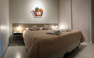a bedroom with a large bed in a room at Alumine in Puerto Madryn