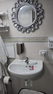 a bathroom with a sink and a mirror on the wall at the lighthouse accommodation in Taranto