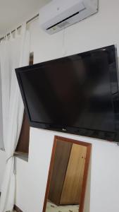 a flat screen tv hanging on a wall at the lighthouse accommodation in Taranto