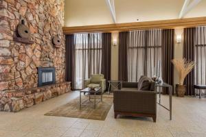 a living room with a stone wall at Best Western Town and Country Inn in Cedar City