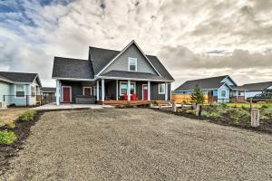 a house with a driveway in front of some houses at Ocean Shores Getaway with Fireplace and Hot Tub! in Ocean Shores
