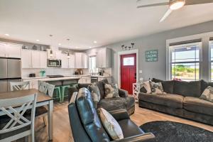 a living room with a couch and a table at Ocean Shores Getaway with Fireplace and Hot Tub! in Ocean Shores