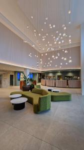 a lobby with a couch and tables in a building at Radisson Blu Hotel Dublin Airport in Cloghran