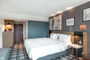 Ένα ή περισσότερα κρεβάτια σε δωμάτιο στο Radisson Blu Hotel Karlsruhe