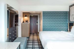 Ένα ή περισσότερα κρεβάτια σε δωμάτιο στο Radisson Blu Hotel Karlsruhe