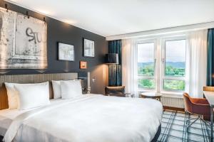 Ένα ή περισσότερα κρεβάτια σε δωμάτιο στο Radisson Blu Hotel Karlsruhe