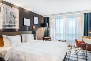 Ένα ή περισσότερα κρεβάτια σε δωμάτιο στο Radisson Blu Hotel Karlsruhe