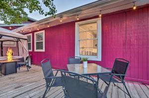 a pink house with a table and chairs on a deck at Aggie Game Day Retreat about 1 Mi to Texas AandM! in Bryan