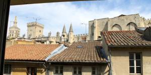 a view of a city with buildings and roofs at Studio Vue Palais des Papes in Avignon