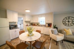 a kitchen and living room with a table and chairs at Adorable and Cozy Bungalow in Great Falls