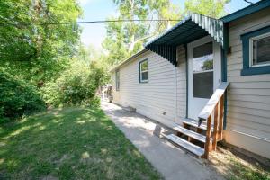 a house with a porch and a bench next to it at Adorable and Cozy Bungalow in Great Falls