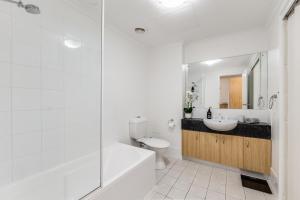 a bathroom with a toilet and a sink and a shower at Hurtle Views in Adelaide