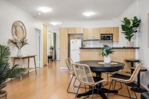 a kitchen and dining room with a table and chairs at Hurtle Views in Adelaide