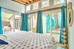 a bedroom with a bed in a room with windows at Luxury Spa Retreat Private Courtyard and More! in Hastings