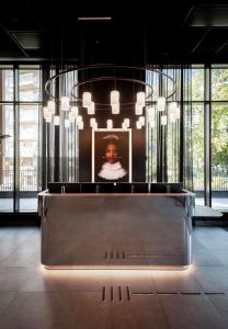 a room with a table with a picture on the wall at Radisson RED Oslo Okern in Oslo