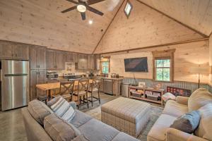 a living room with a couch and a kitchen at Stunning Cabin Getaway with Private Hot Tub! in Rising Fawn
