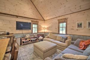 a living room with a couch and a tv at Stunning Cabin Getaway with Private Hot Tub! in Rising Fawn