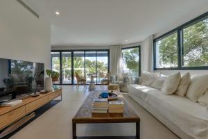 a living room with a white couch and a table at Buenavista by Almarina Villas in Benissa