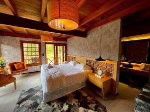 a bedroom with a large bed in a room at WoodStone Hotel Fazenda in Gramado