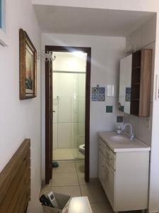 a bathroom with a shower and a sink and a toilet at Residencial Dois Amores Apartamentos in Florianópolis