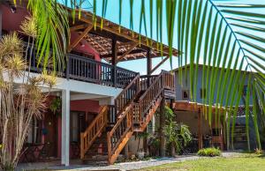 a house with stairs on the side of it at Suítes Las Flores Maresias in Maresias