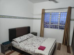 a bedroom with a bed and a large window at homestay seaview ainee - Muslim sahaja in Kuala Terengganu