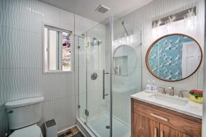 a bathroom with a shower and a toilet and a sink at Picturesque Cabin 2 Balconies, Walk to Lake! in Crestline +41 photos