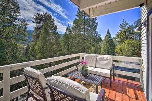 a porch with two chairs and a table on a balcony at Picturesque Cabin 2 Balconies, Walk to Lake! in Crestline