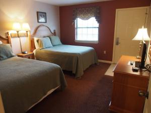 a hotel room with two beds and a window at Heart of Gatlinburg, sleep 6 in Gatlinburg +12 photos