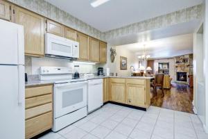 a kitchen with white appliances and wooden cabinets at Heart of Gatlinburg in Gatlinburg