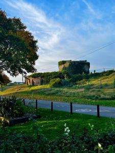 a castle sitting on top of a hill with a road at Seascape Camber Sands Holiday Let in Camber