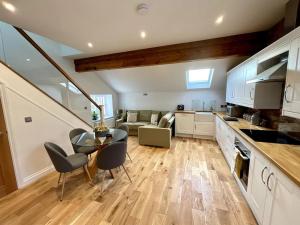 a kitchen and living room with a table and chairs at Apt D in Old Grade 2 Converted Farmhouse in Market Weighton