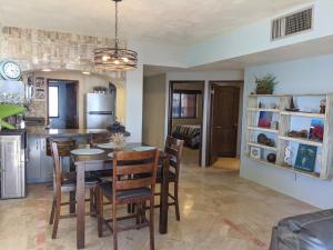 a kitchen and dining room with a table and chairs at Marina Pinacate B-201 in Puerto Peñasco