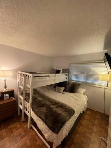 a white bunk bed in a room with a window at Beaver Creek 2 Bed 2 Bath Condo 1 MIN Walk to Elk Lot in Avon