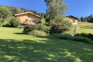 a house in the middle of a green yard at Cosy chalet with garden in Notre-Dame-de-Bellecombe